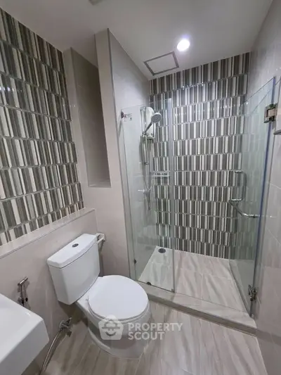 Modern bathroom with stylish tile design and glass shower enclosure