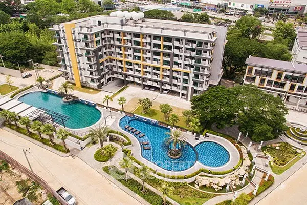 Modern apartment complex with pool and landscaped gardens