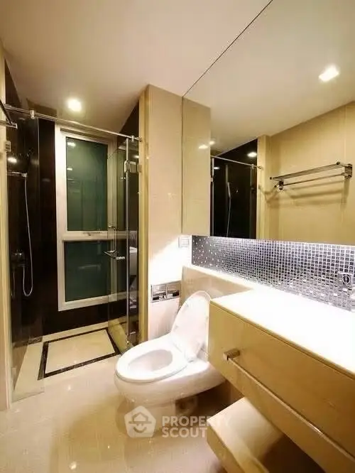 Modern bathroom with sleek fixtures and glass shower enclosure