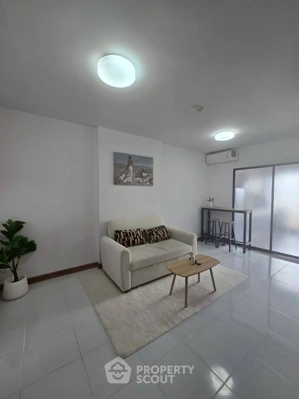 Modern living room with sleek design, featuring a cozy sofa, stylish coffee table, and elegant decor.