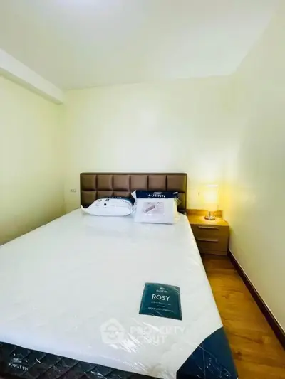 Cozy bedroom with modern decor and soft lighting, perfect for relaxation.