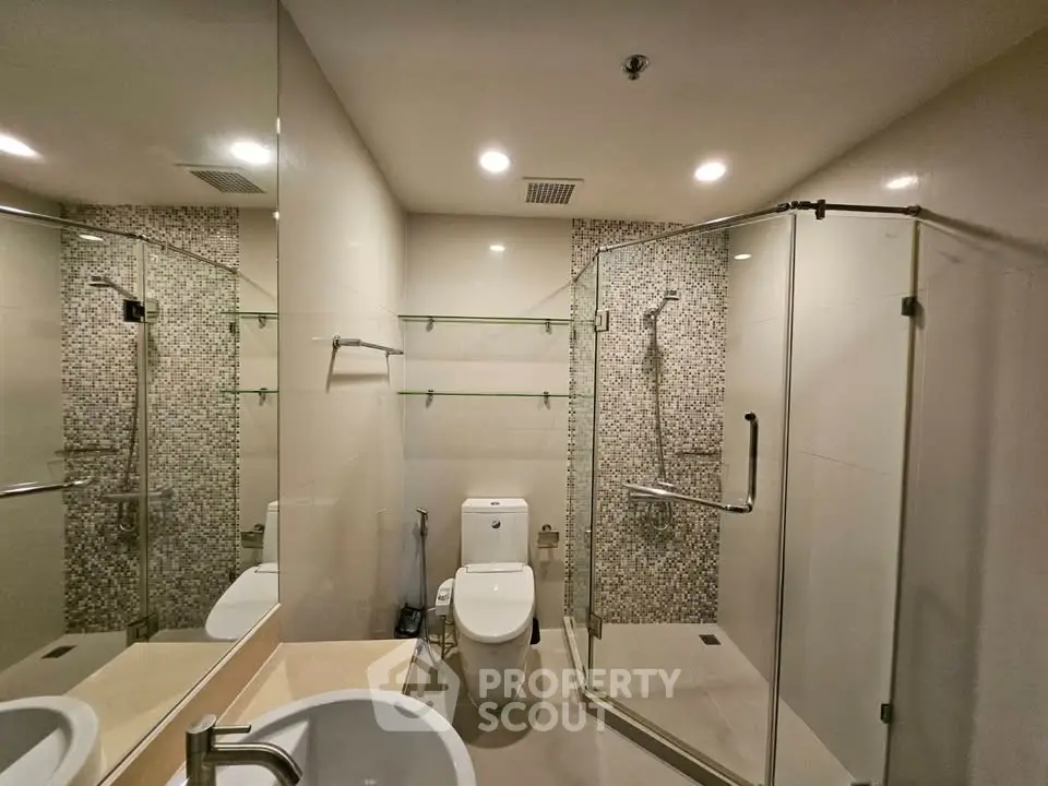 Modern bathroom with glass shower and stylish tile accents