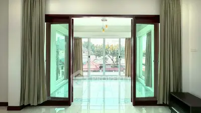 Spacious living room with large windows and natural light, perfect for modern living.