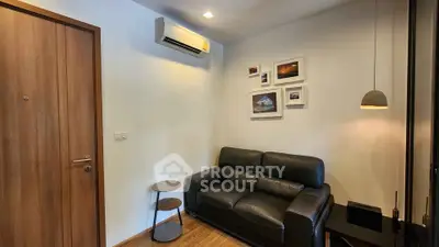 Cozy living room with black leather sofa and modern decor