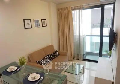 Modern living room with glass dining table and cozy sofa near balcony