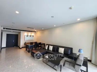 Spacious modern living room with elegant furniture and ample natural light.