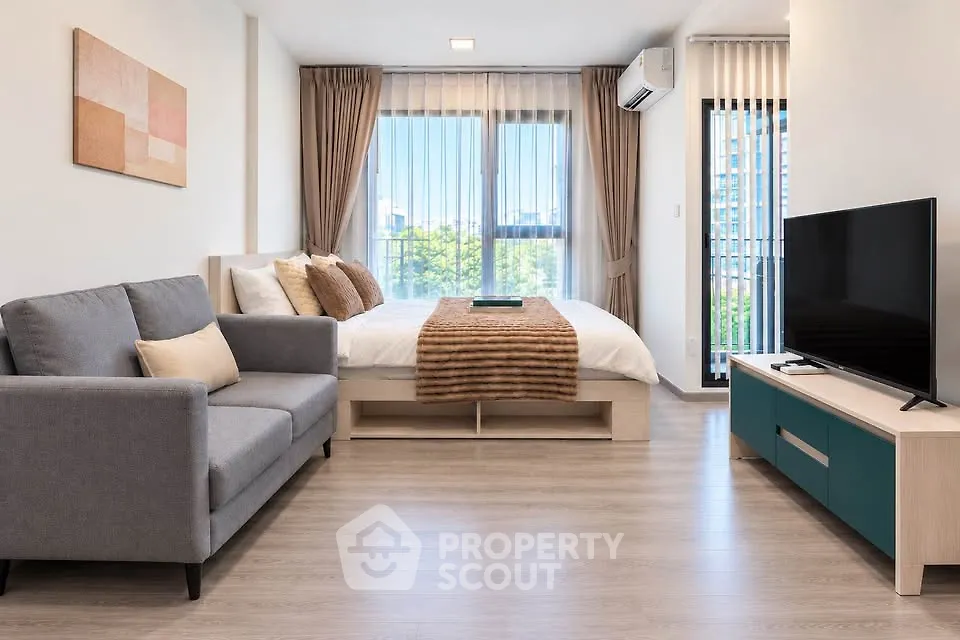 Modern studio apartment with cozy living area and stylish decor