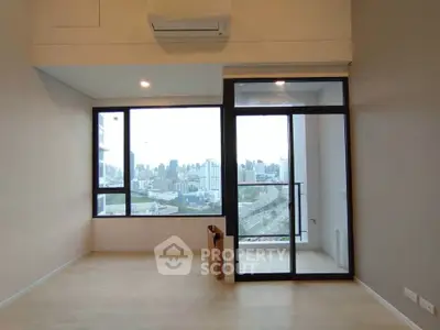 Spacious modern living room with large windows and city view balcony