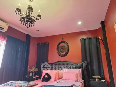 Luxurious bedroom with elegant chandelier and plush decor