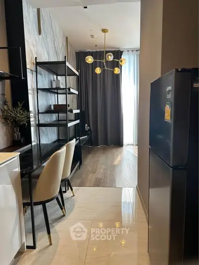 Modern kitchen with sleek design and elegant lighting in a stylish apartment.