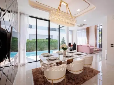 Luxurious open-plan living and dining area with pool view, elegant chandelier, and modern decor.