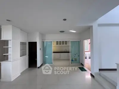 Spacious modern kitchen with sliding glass doors and sleek white cabinetry