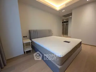 Spacious modern bedroom with elegant lighting and large bed