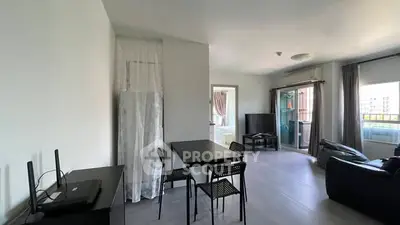 Spacious modern living room with balcony access and sleek furniture