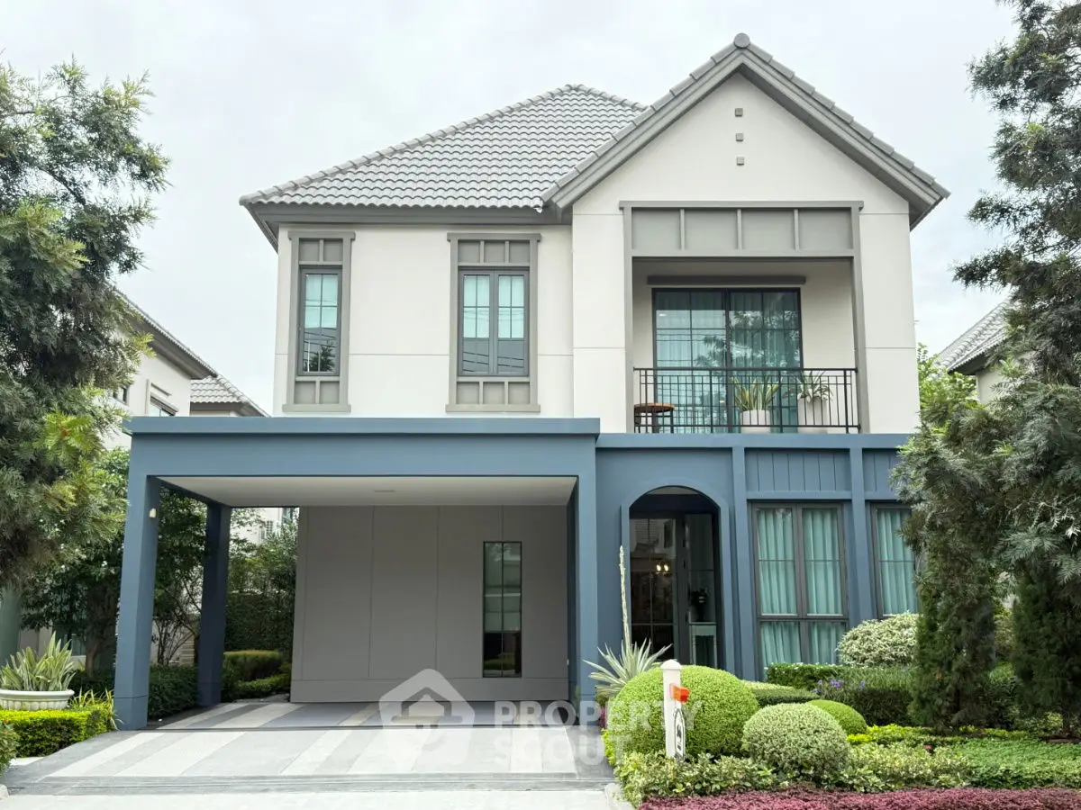 Elegant modern two-story house with manicured garden and spacious carport