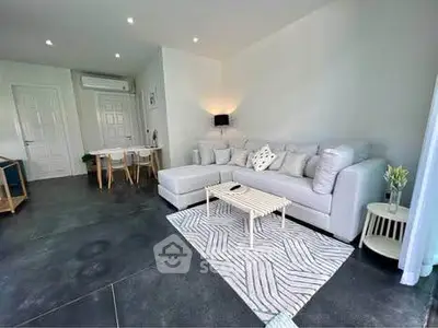 Modern living room with stylish decor and cozy seating area, perfect for relaxation and entertainment.