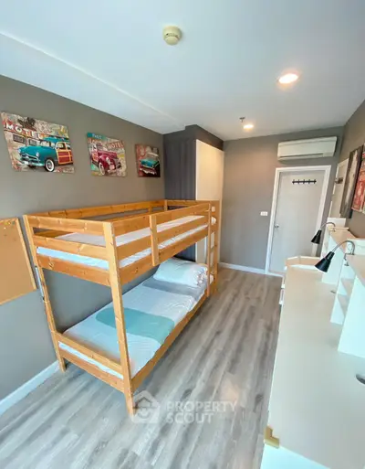 Modern bedroom with bunk bed and stylish decor, perfect for maximizing space in urban living.