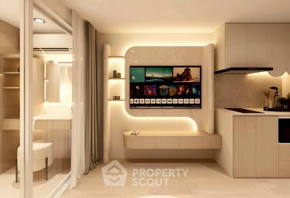 Modern living room with sleek TV setup and stylish kitchen area in open layout apartment.