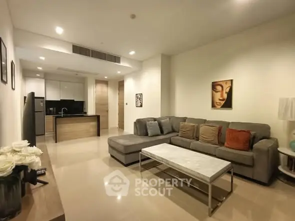 Modern living room with open kitchen layout and stylish decor