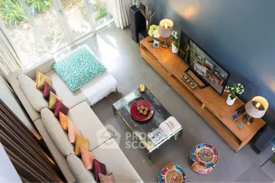 Stylish living room with modern decor, large sofa, and entertainment center, perfect for relaxation and gatherings.