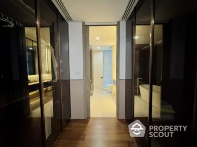 Luxurious hallway leading to a modern bathroom with elegant design and ambient lighting.