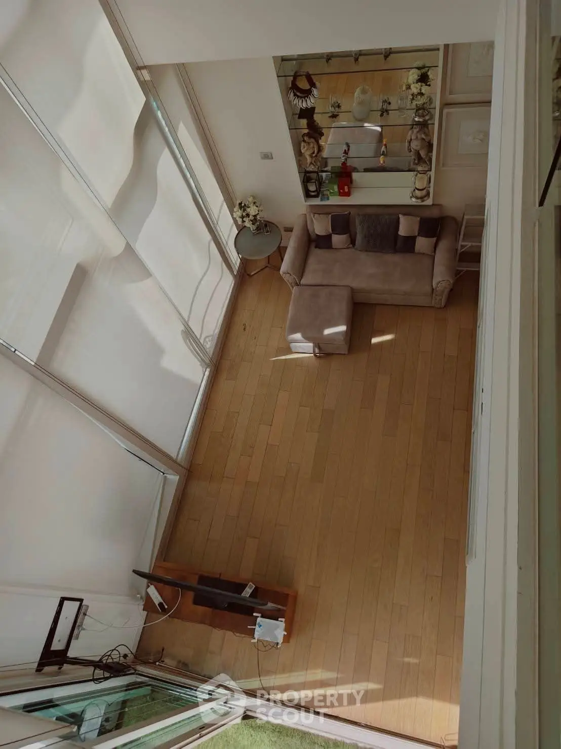 Spacious living room with modern decor and large windows for natural light