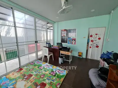 Bright study room with colorful play mat and sliding glass doors