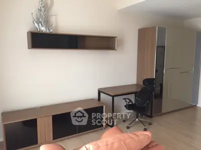 Modern minimalist living room with sleek wooden furniture, ample natural light, and a cozy ambiance perfect for relaxation or work from home setup.