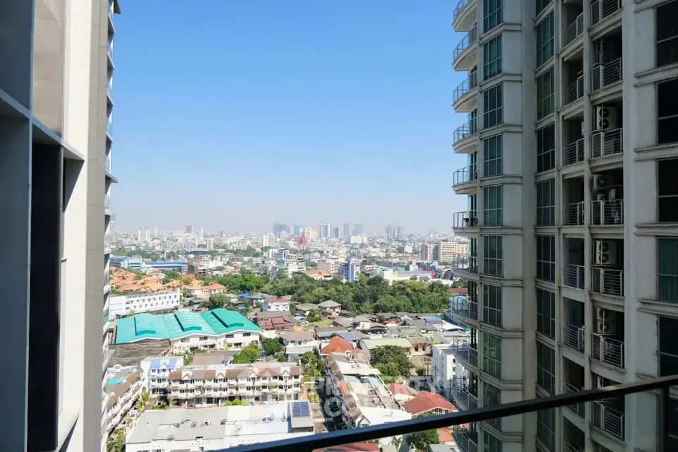 Stunning cityscape view from high-rise balcony in urban residential area.