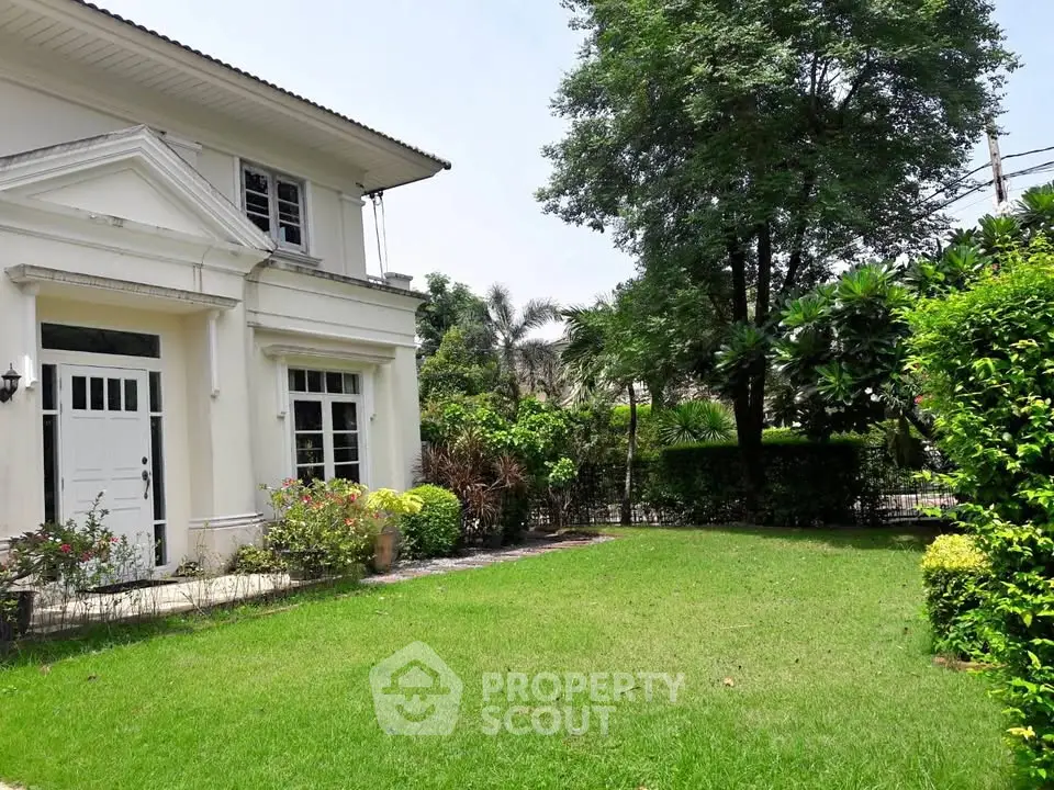 Charming suburban home with lush green garden and classic architecture