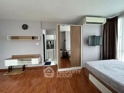 Spacious bedroom with modern furnishings and natural light