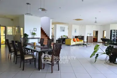 Spacious open-plan living room with modern dining area and stylish decor