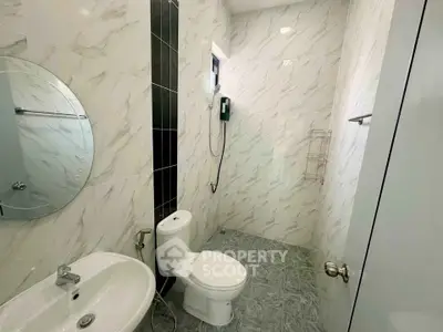 Modern bathroom with marble tiles and sleek fixtures