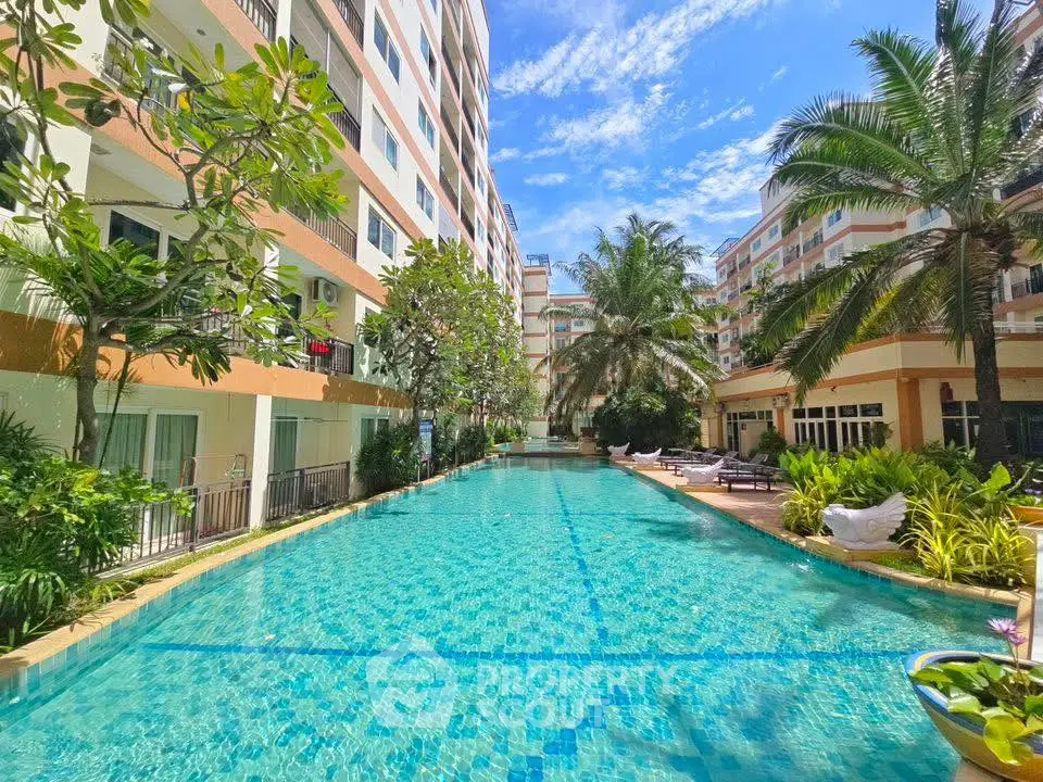 Luxurious apartment complex with stunning pool and lush greenery