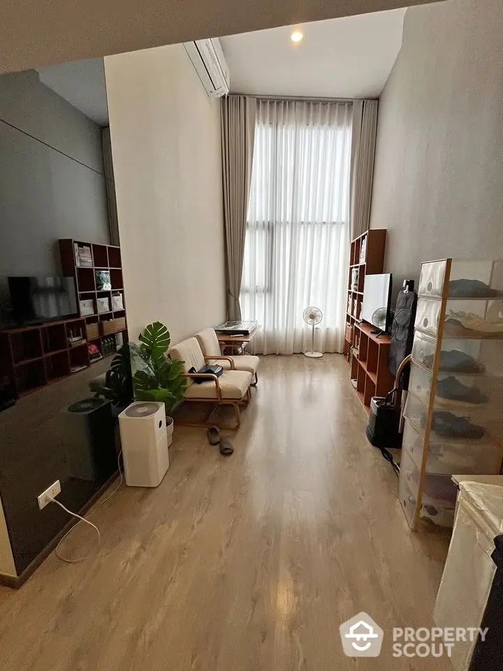 Modern living room with high ceilings and natural light