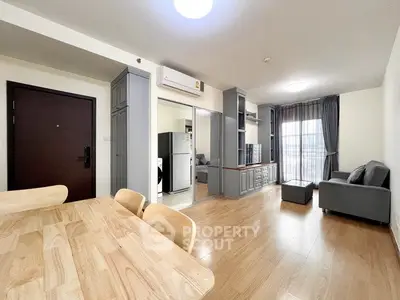 Spacious modern living room with wooden flooring and natural light
