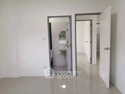 Modern minimalist interior with tiled bathroom and open doors