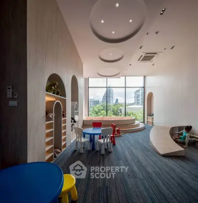 Spacious children's playroom with modern design and large windows offering city views.