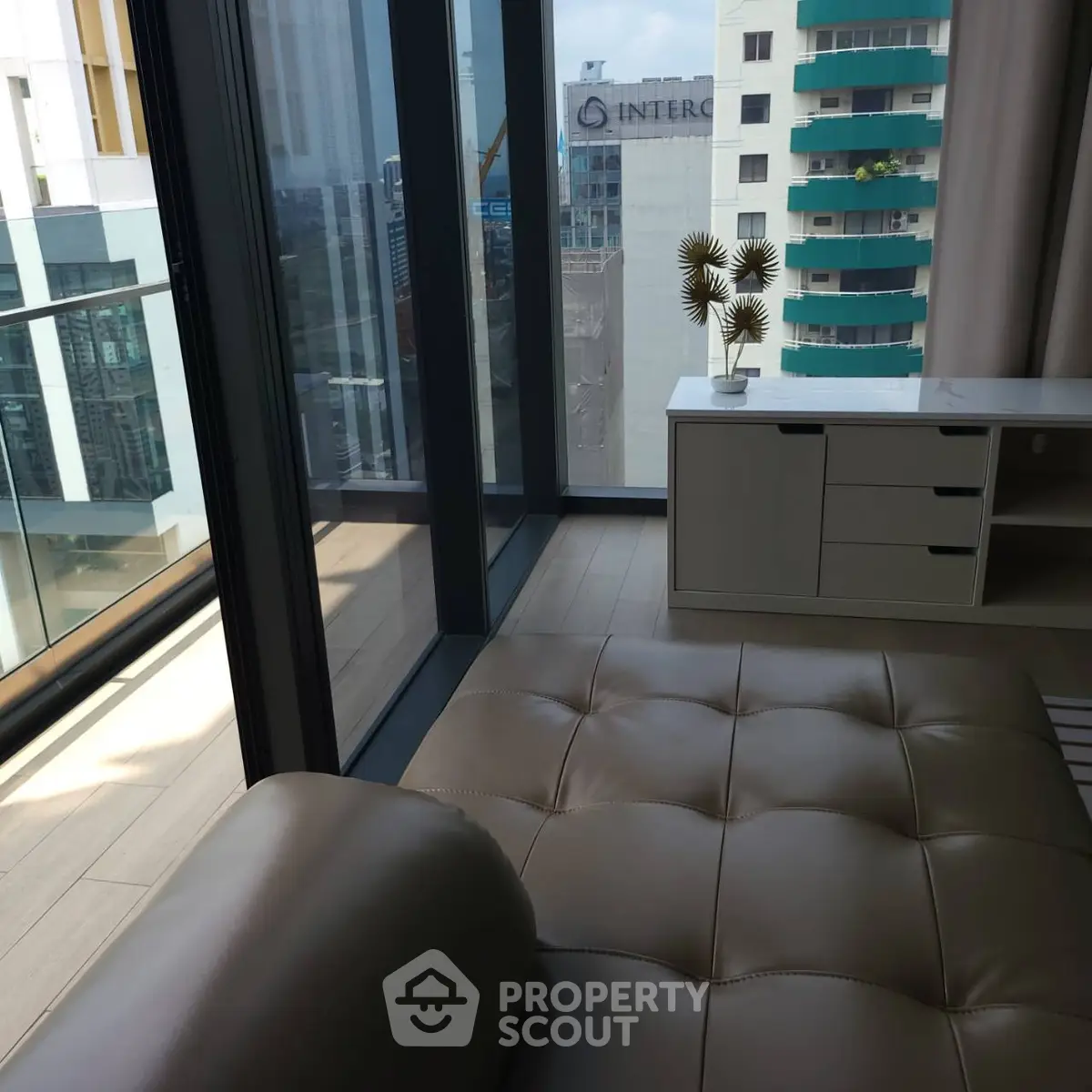 Luxurious living room with floor-to-ceiling windows and stunning city view