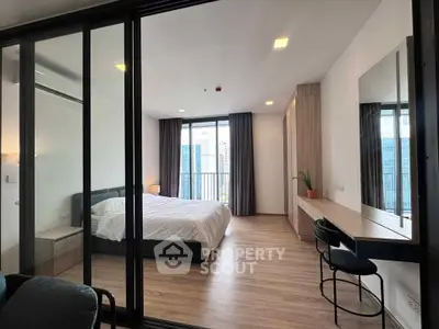 Modern bedroom with floor-to-ceiling windows and city view, featuring sleek furnishings and a cozy ambiance.