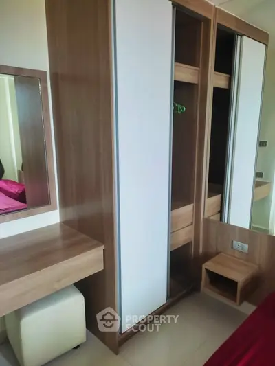 Modern bedroom with sleek wardrobe and vanity in stylish apartment