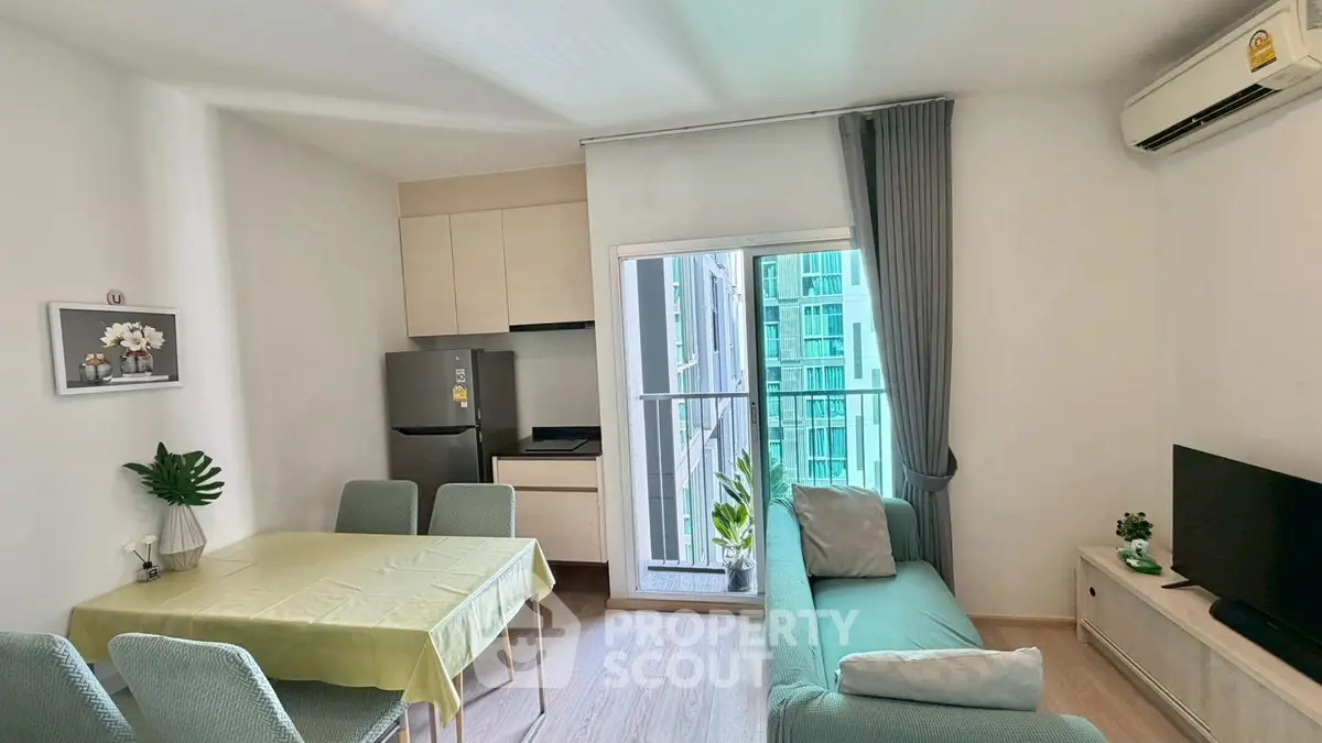 Modern living room with open kitchen and balcony in a stylish apartment