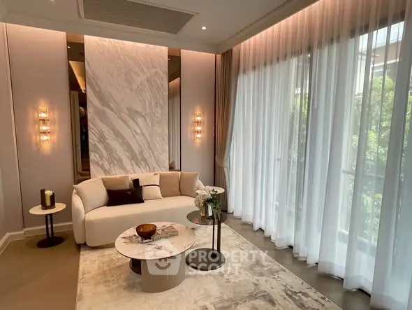 Luxurious living room with elegant decor and large windows for natural light.