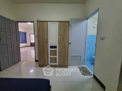 Spacious bedroom with wardrobe and ensuite bathroom in modern apartment