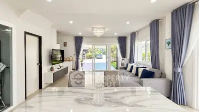 Spacious modern living room with elegant decor and large windows offering a bright and airy atmosphere.