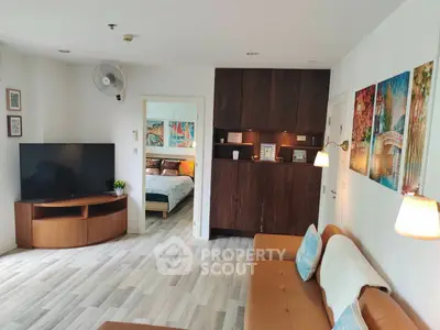 Stylish living room with modern decor and open view to bedroom