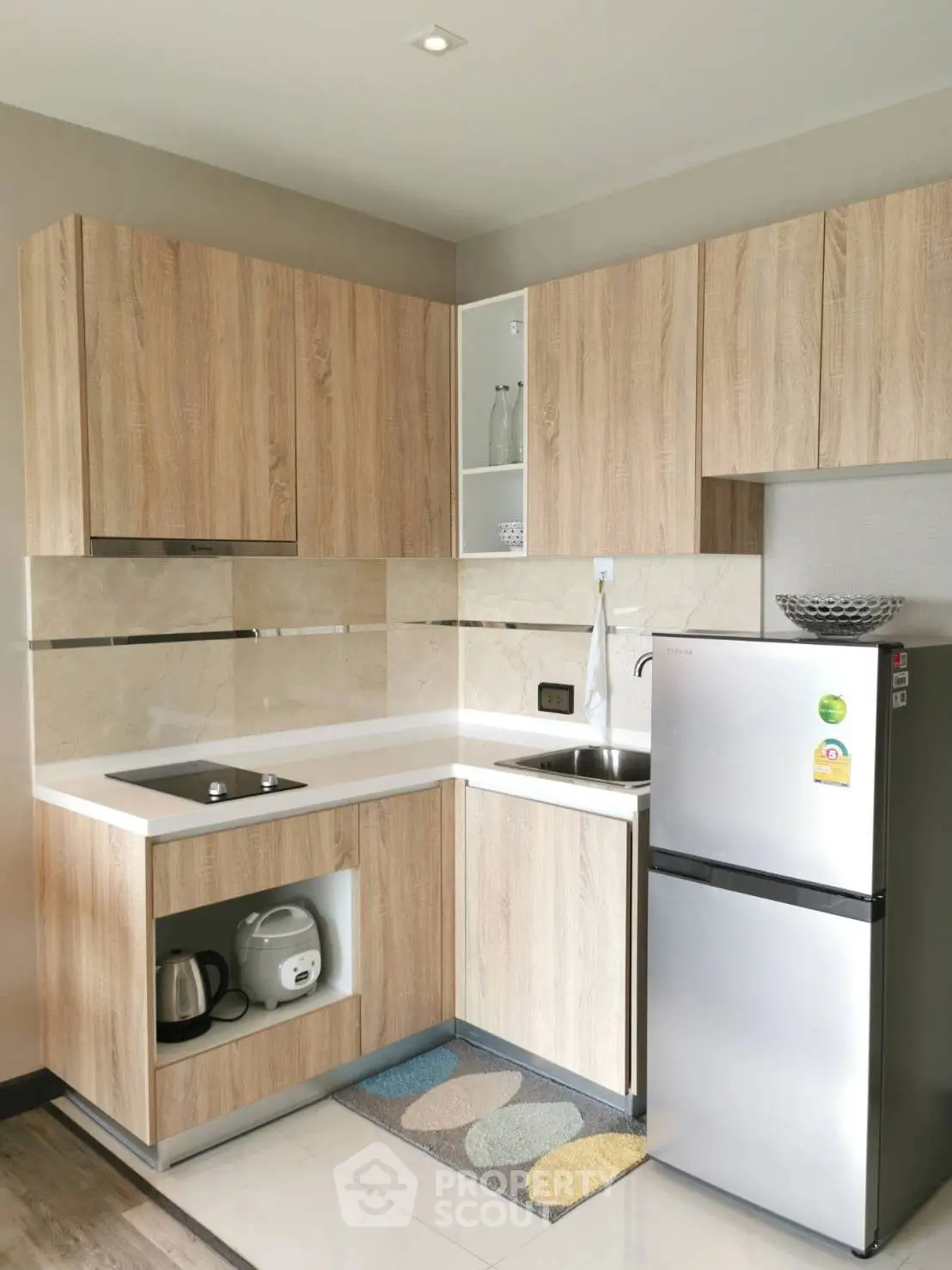 Modern kitchen with sleek wooden cabinets and stainless steel appliances