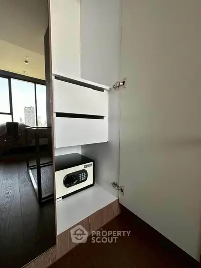Modern apartment interior with built-in safe in sleek cabinet
