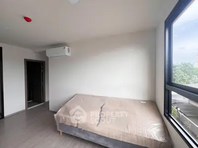 Modern bedroom with large window and air conditioning unit