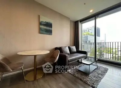 Modern living room with stylish furniture and large window offering city view